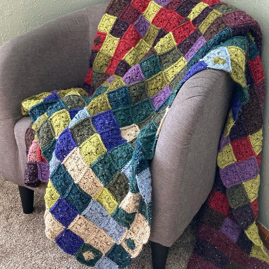 a crochet patchwork style quilt in random colors to represent a temperature blanket