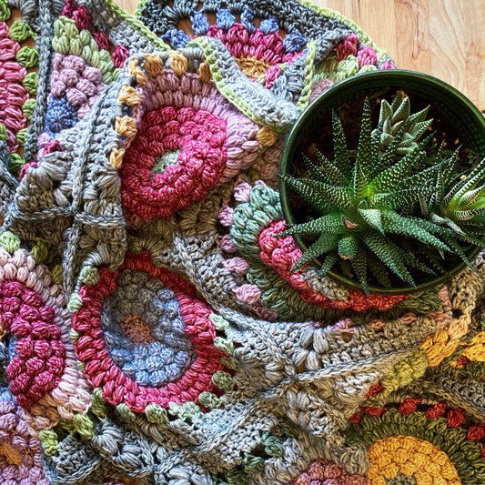 crochet flower squares seamed together to make a blanket