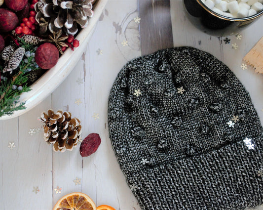 knit hat with a double brim and bobble stitches to represent bells