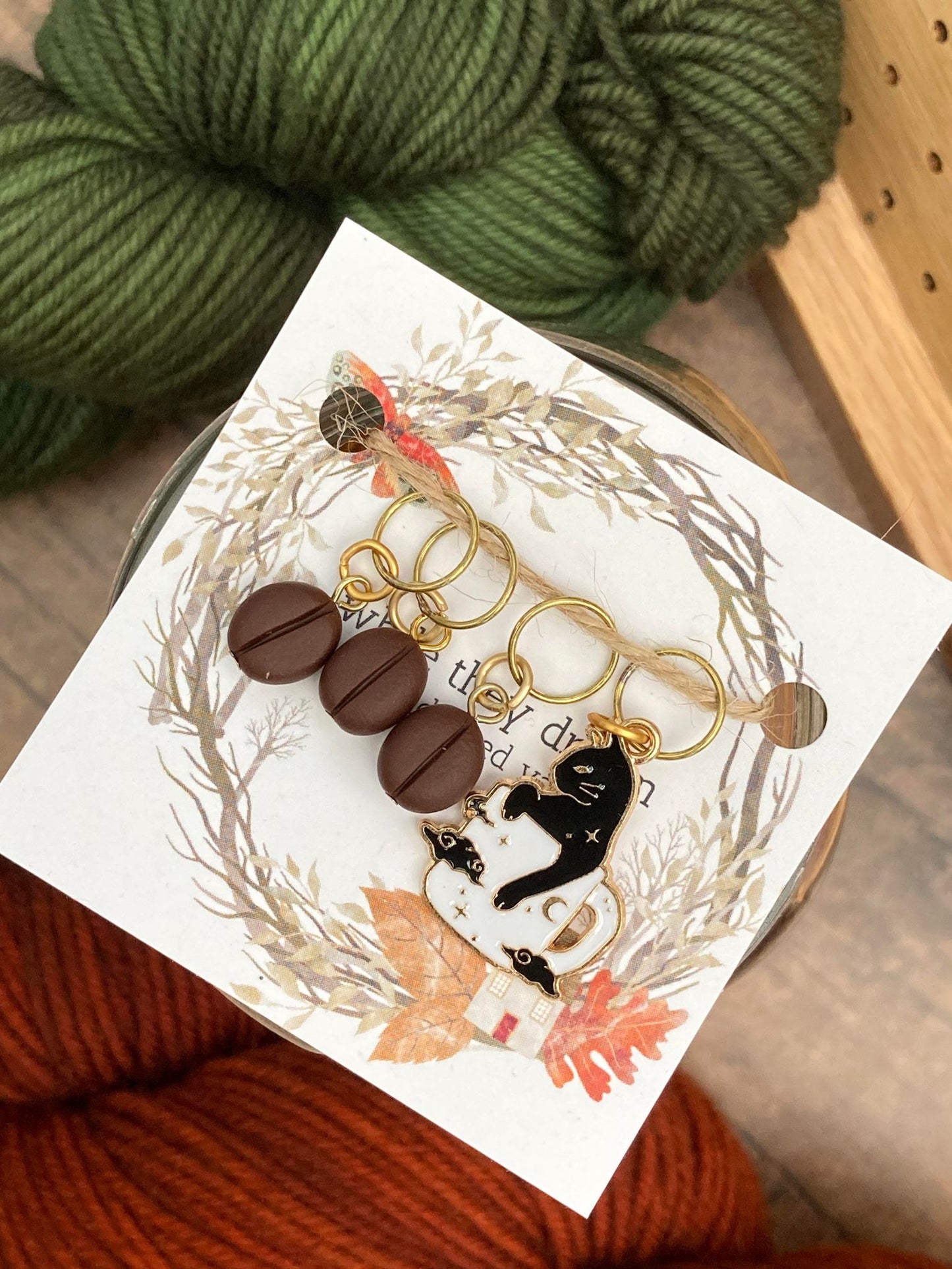 three coffee beans and a cat in a coffee cup stitch markers for knitting and crocheters