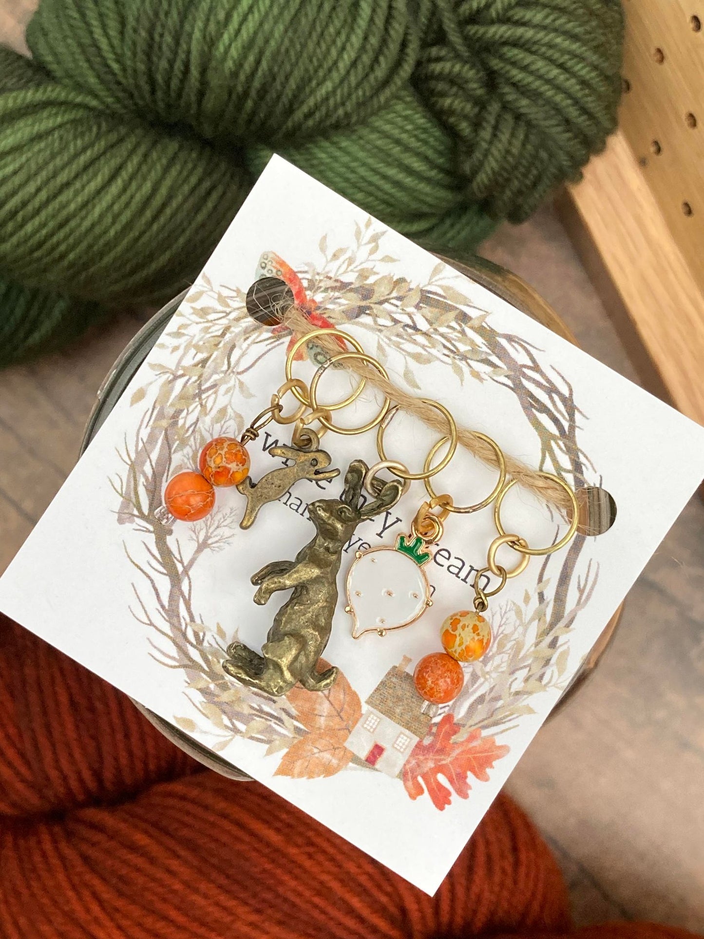 gemstone stitch markers, one small brass rabbit stitch marker, one 3D brass rabbit stitch marker, and one turnip stitch marker