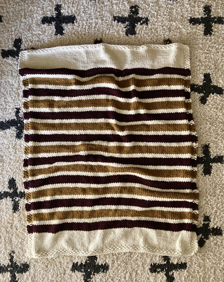 super bulky knit blanket with alternating stripes of color