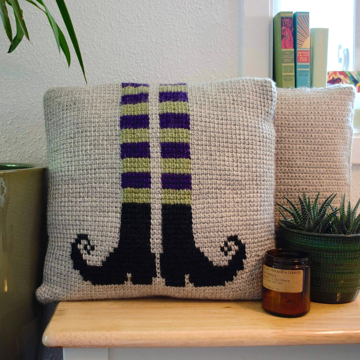 tunisian crochet pillow cover with witch legs