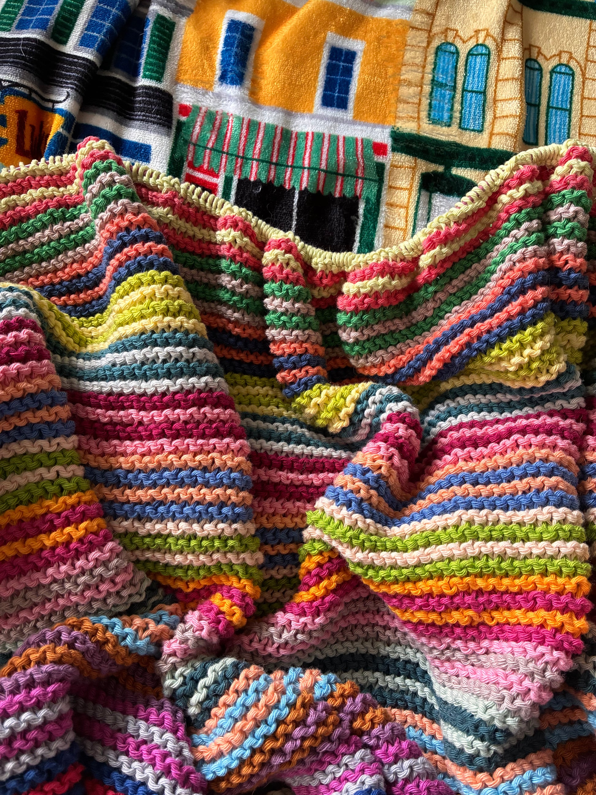 Knit garter stitch blanket using a rainbow of colors in Scheepjes Cahlista yarn