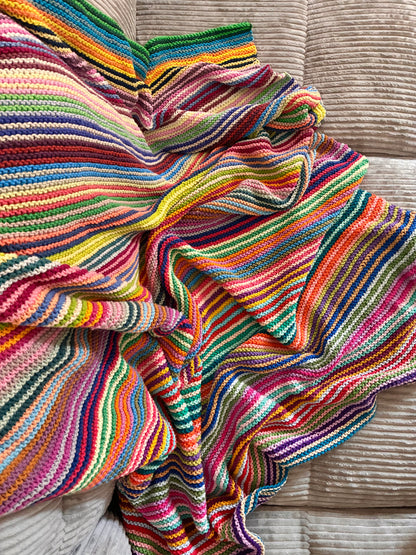 Knit garter stitch blanket using a rainbow of colors in Scheepjes Cahlista yarn
