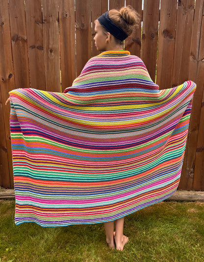Knit garter stitch blanket using a rainbow of colors in Scheepjes Cahlista yarn