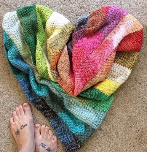 tunisian crochet chevron style blanket created by using mini skeins and crochet panels, joined together as you go