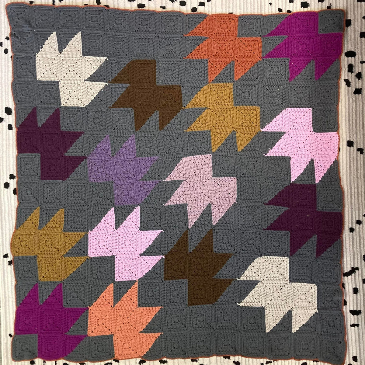 a Crochet quilt inspired Blanket made of Crochet Granny Squares to create a pattern of leaves