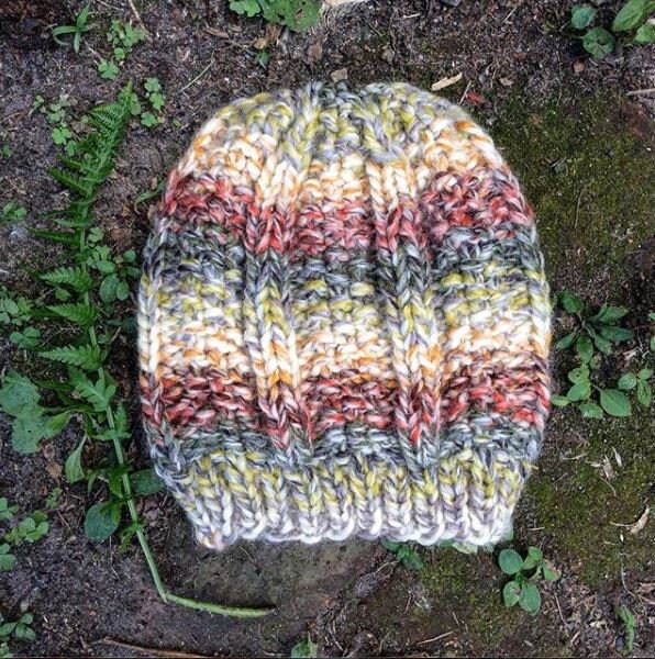 Super bulky knit hat with columns of knit stitch and seed stitch