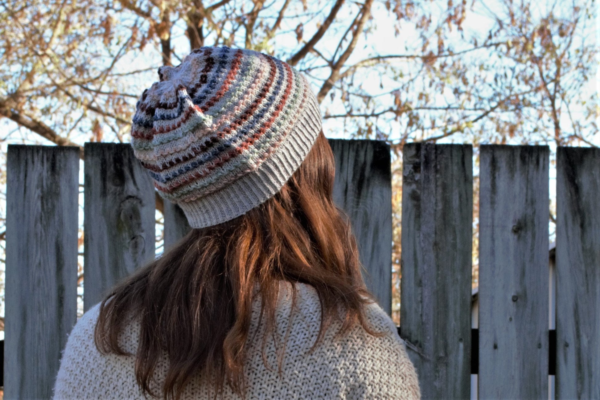 Knit hat with single horizontal rows of tiny bobble stitches in alternating colors