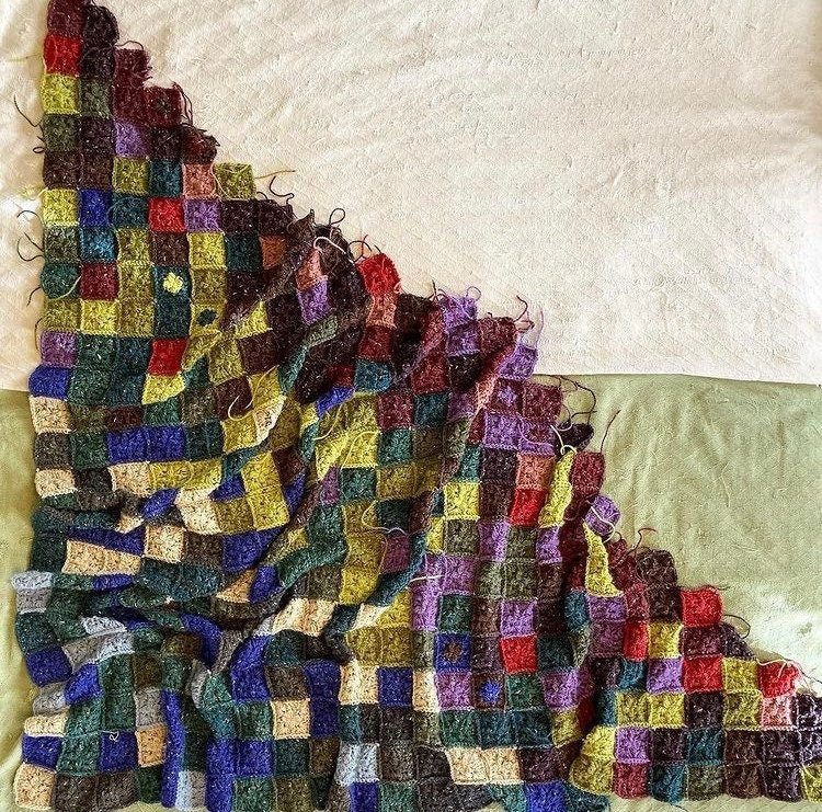 a crochet patchwork style quilt in random colors to represent a temperature blanket